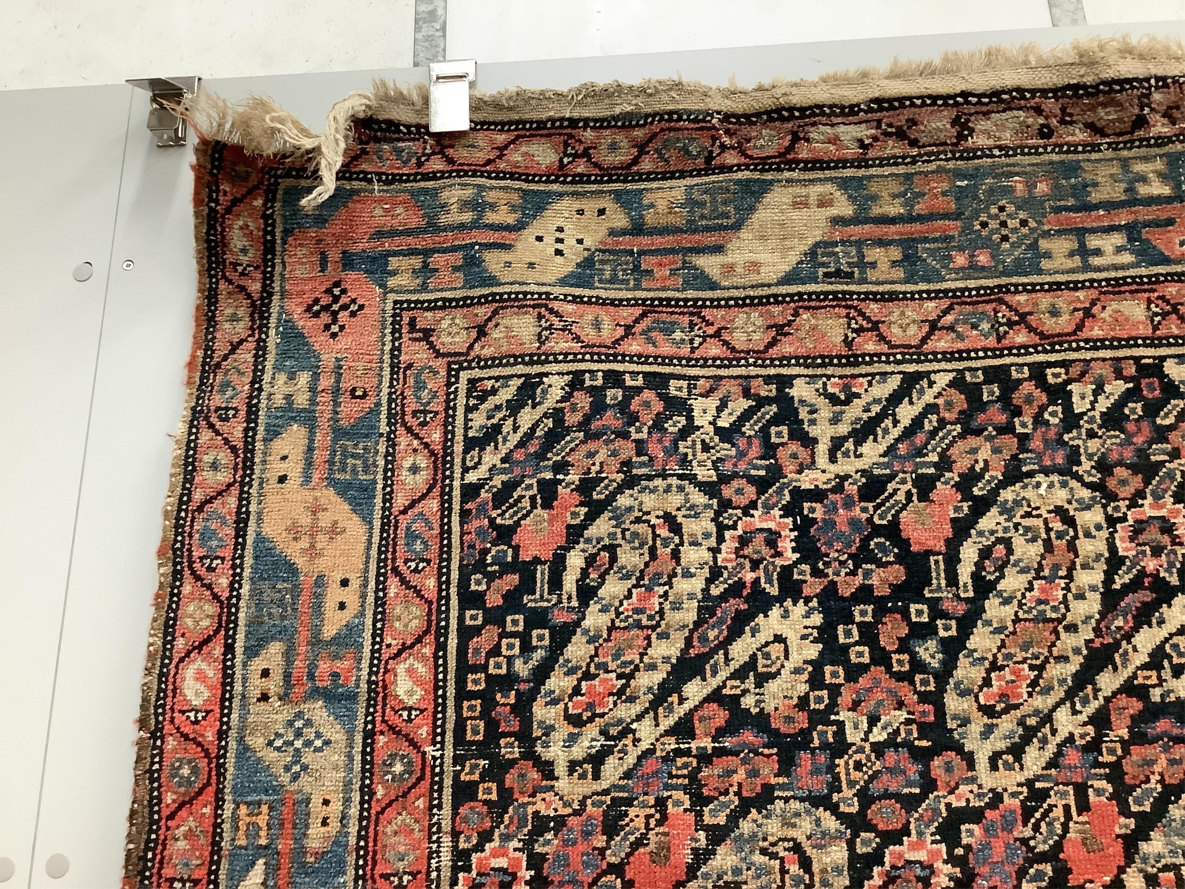 A Persian black ground rug, 140 x 97cm. Condition - faded and worn